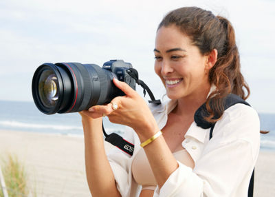 Smiling woman holding camera 